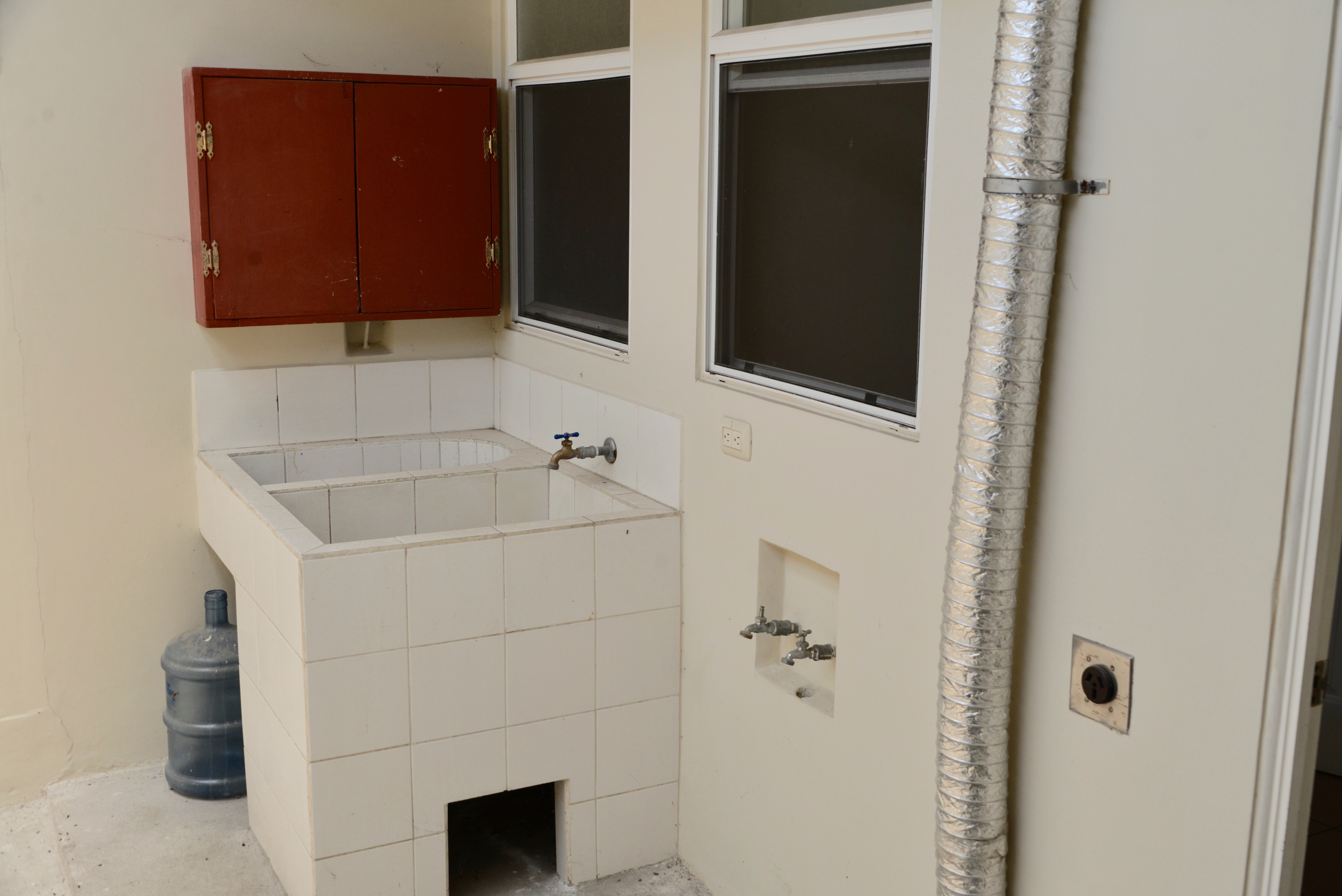 Clean laundry room with space for washer and dryer